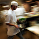 A culinary student hurries through a kitchen